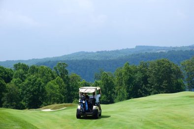 image of golf cart on course in hills