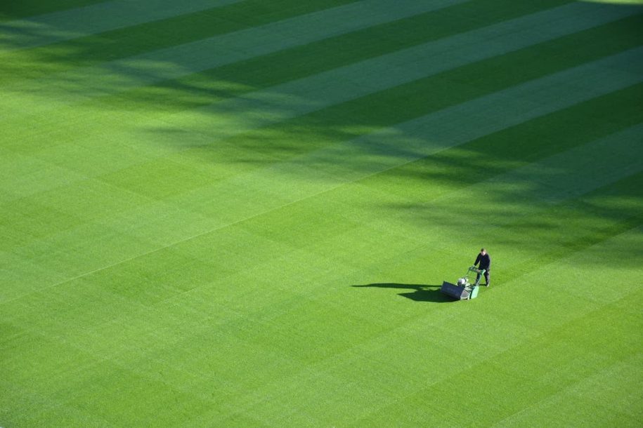 man pushing lawn mower on golf course in Murfreesboro